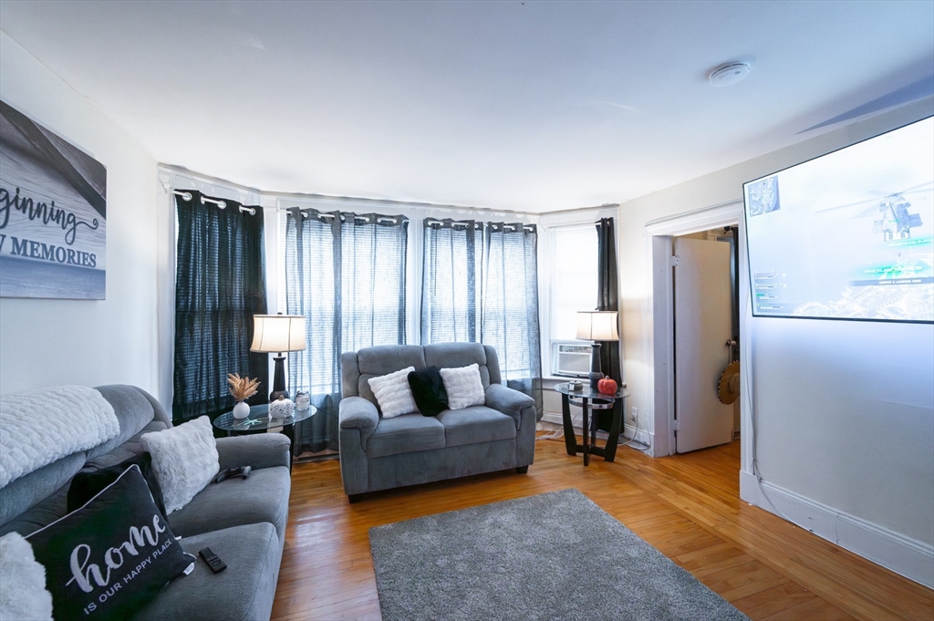 18 Edson Street Lowell, MA 01851 - Photo 33 of 41 a living room with furniture and a window