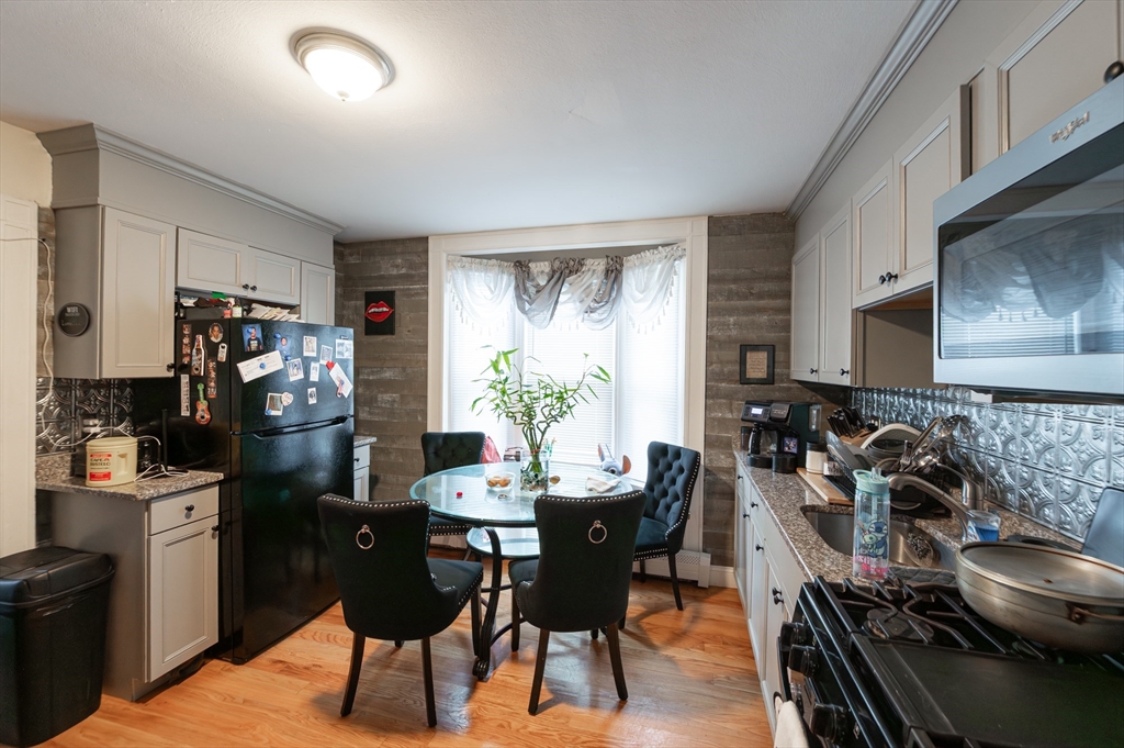 18 Edson Street Lowell, MA 01851 - Photo 5 of 41 a view of a dining room with furniture window and outside view
