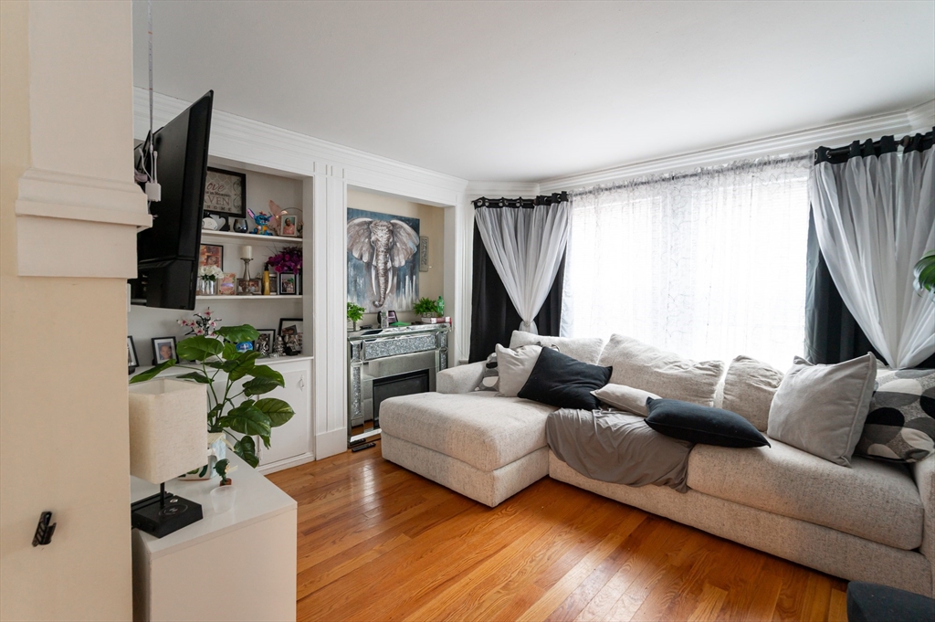 18 Edson Street Lowell, MA 01851 - Photo 7 of 41 a living room with furniture and a flat screen tv