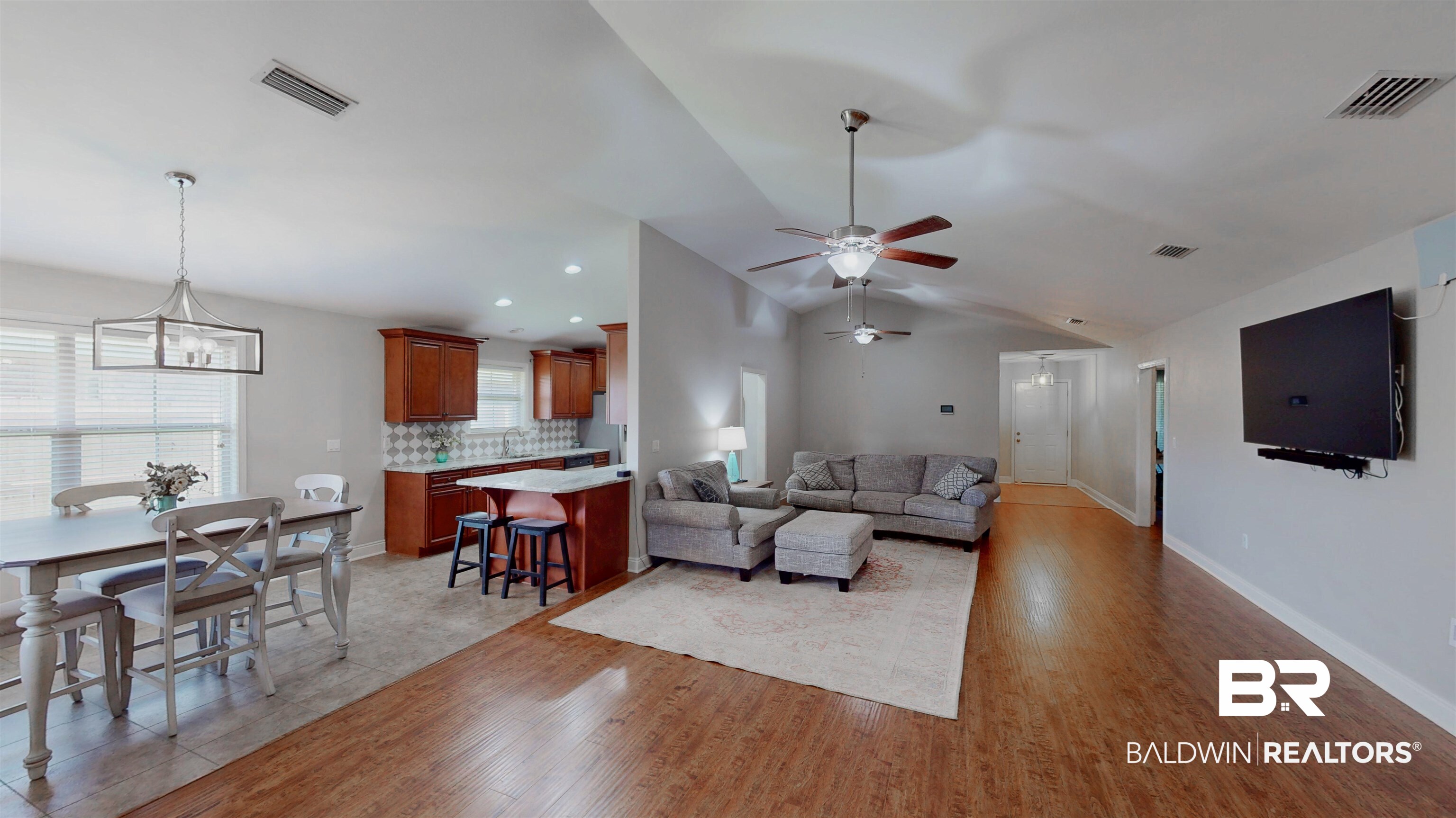 1704 Arcadia Drive Foley, AL 36535 - Photo 19 of 52 Living area with light wood-style flooring, vaulted ceiling, a ceiling fan, and a chandelier