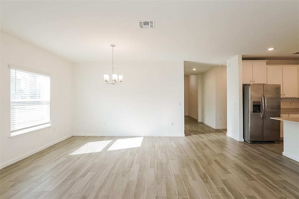 7898 Southwest 74th Loop Ocala, FL 34474 - Photo 10 of 29 wooden floor in an empty room with a window