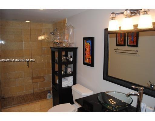 1901 Brickell Avenue, Unit B1711 Miami, FL 33129 - Photo 5 of 9 a bathroom with a sink and a mirror