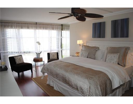 1901 Brickell Avenue, Unit B1711 Miami, FL 33129 - Photo 6 of 9 a bedroom with a bed a table and chair