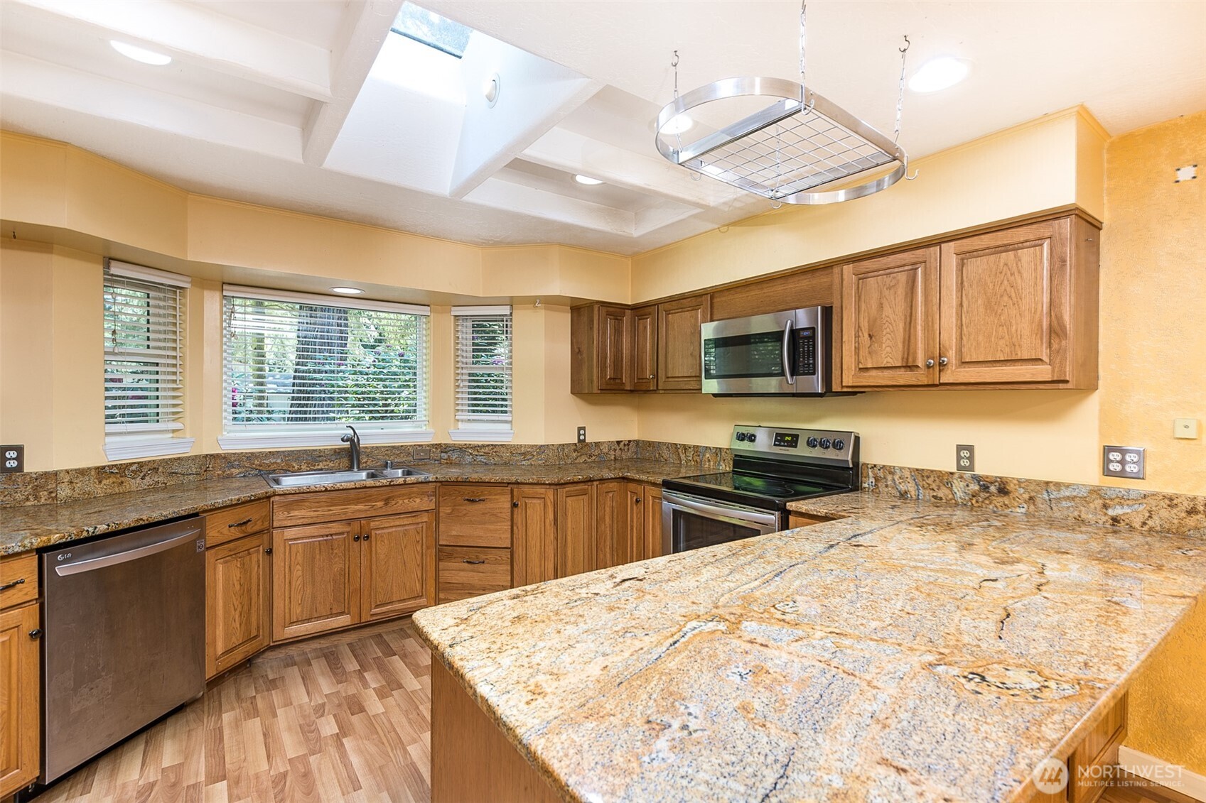 123 Forest Ridge Drive Sequim, WA 98382 - Photo 17 of 32 a kitchen with stainless steel appliances granite countertop sink stove top oven and granite counter top