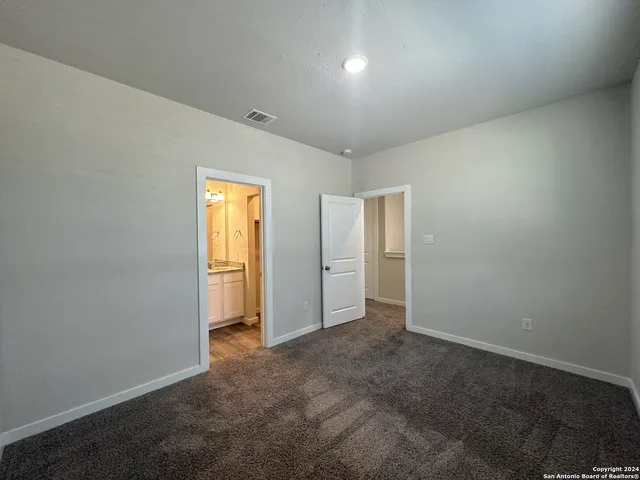 an empty room with closet and a window