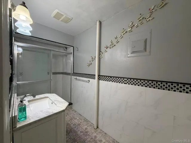 a bathroom with a sink and shower