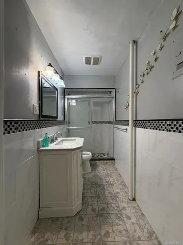 a bathroom with a sink mirror and shower