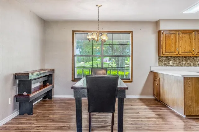 a kitchen with a sink cabinets and wooden floor