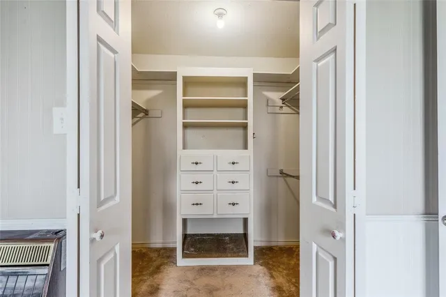 a view of empty room with wooden floor and window