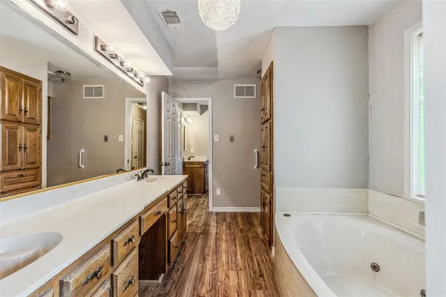 a bathroom with a sink and mirror with toilet