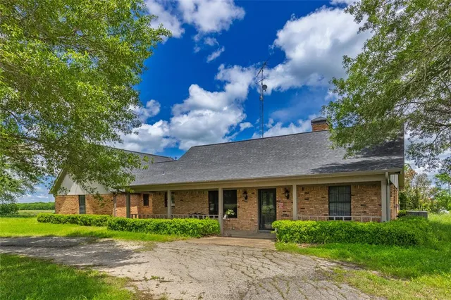 a view of green field with sitting area