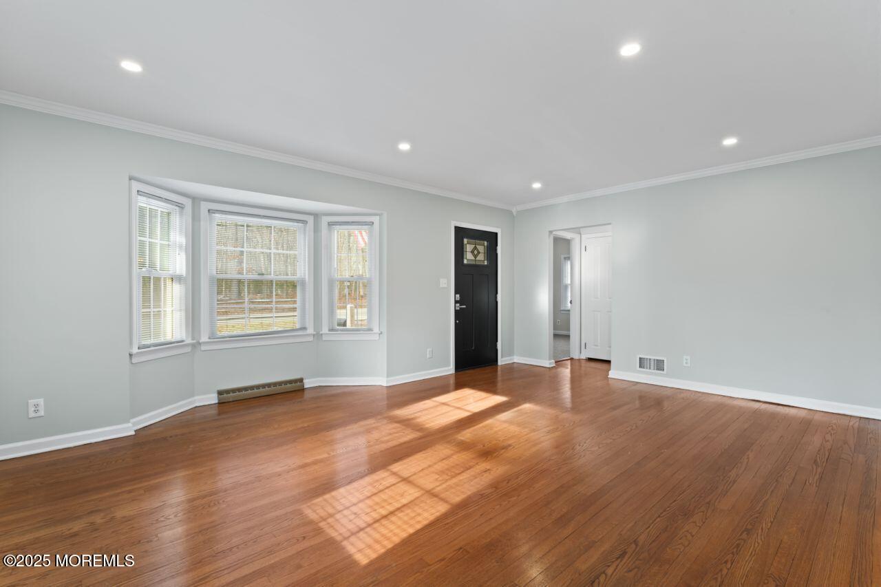 31 Phalanx Road Lincroft, NJ 07738 - Photo 12 of 28 a view of an empty room with wooden floor and windows