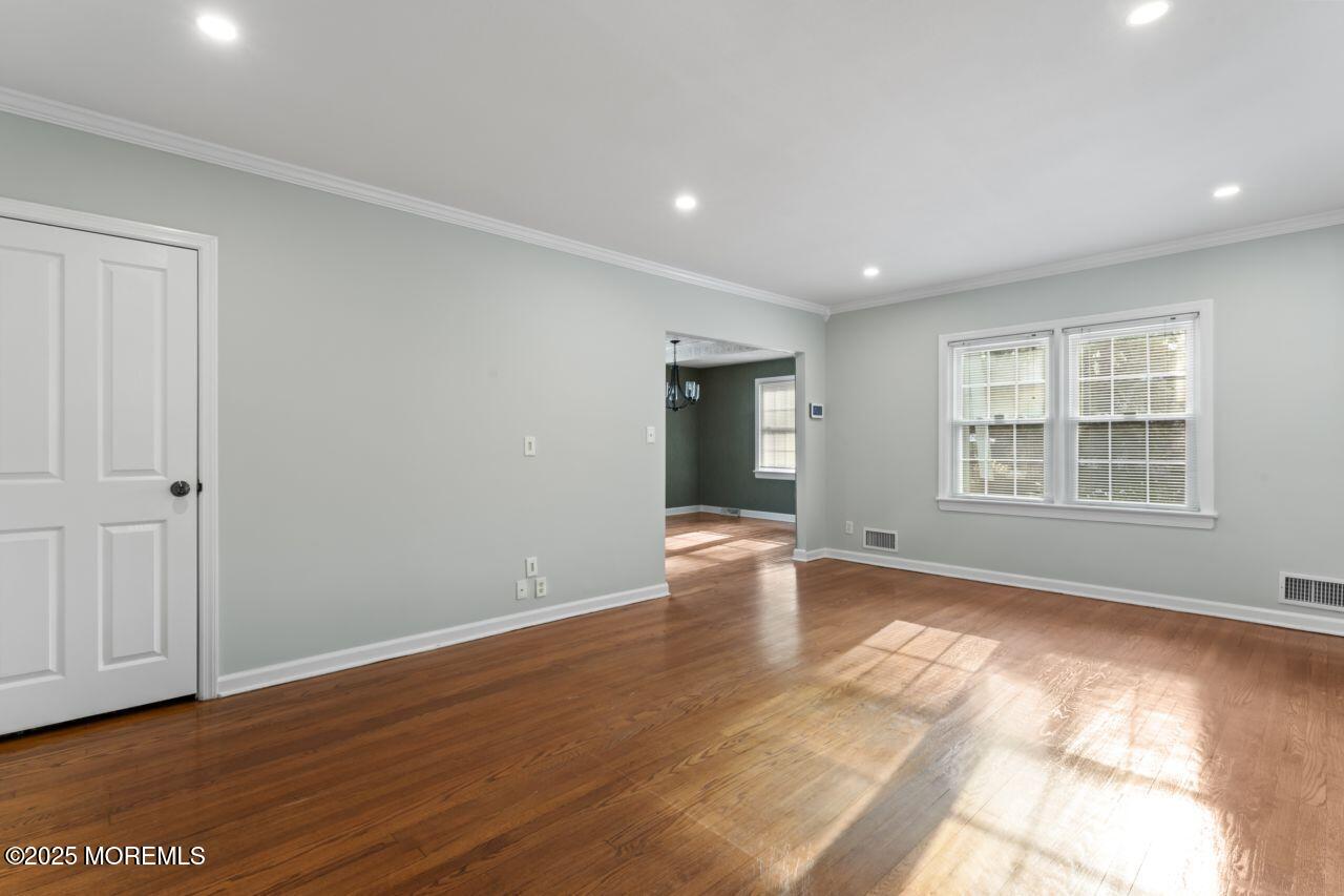 31 Phalanx Road Lincroft, NJ 07738 - Photo 13 of 28 a view of an empty room with wooden floor and windows