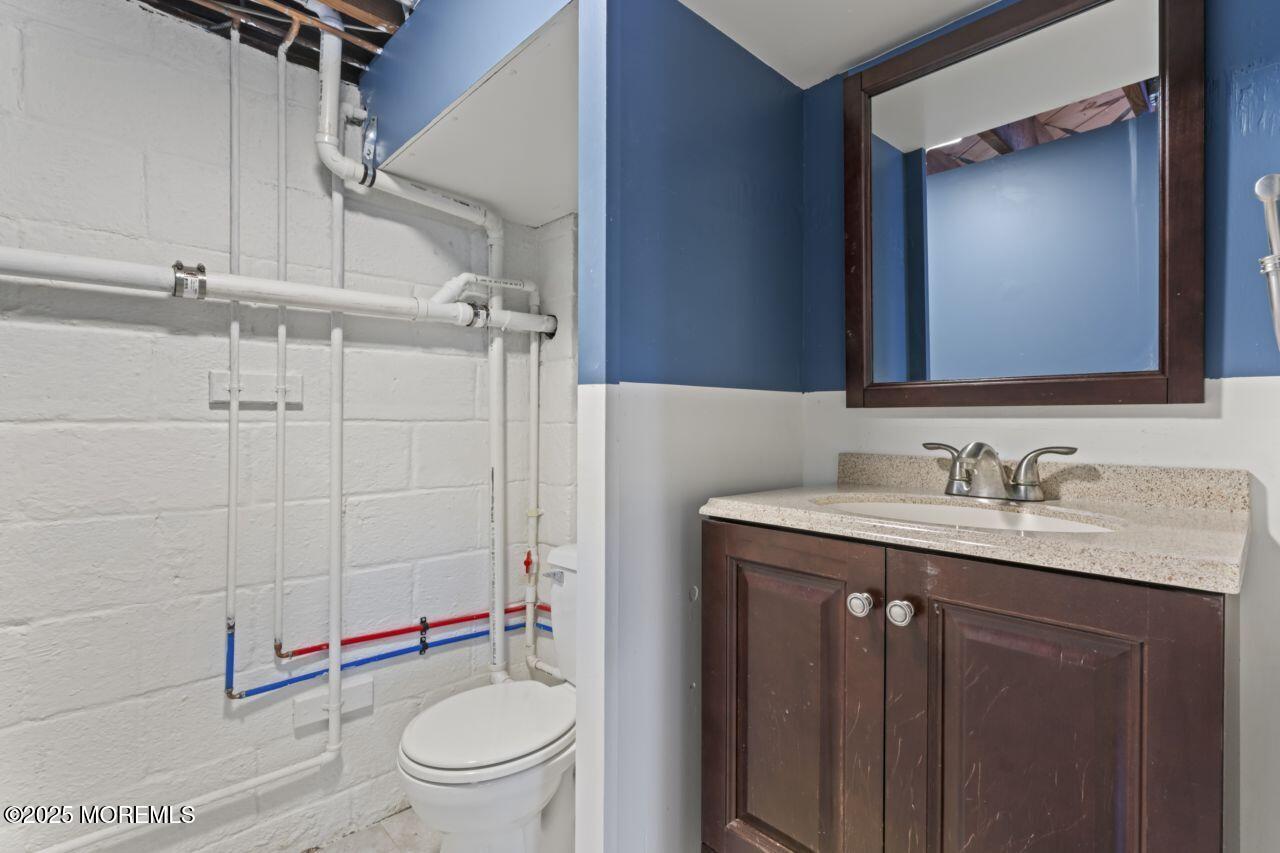 31 Phalanx Road Lincroft, NJ 07738 - Photo 17 of 28 a bathroom with a granite countertop toilet sink and mirror