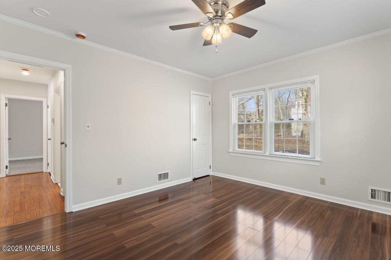 31 Phalanx Road Lincroft, NJ 07738 - Photo 6 of 28 a view of an empty room with wooden floor and a window