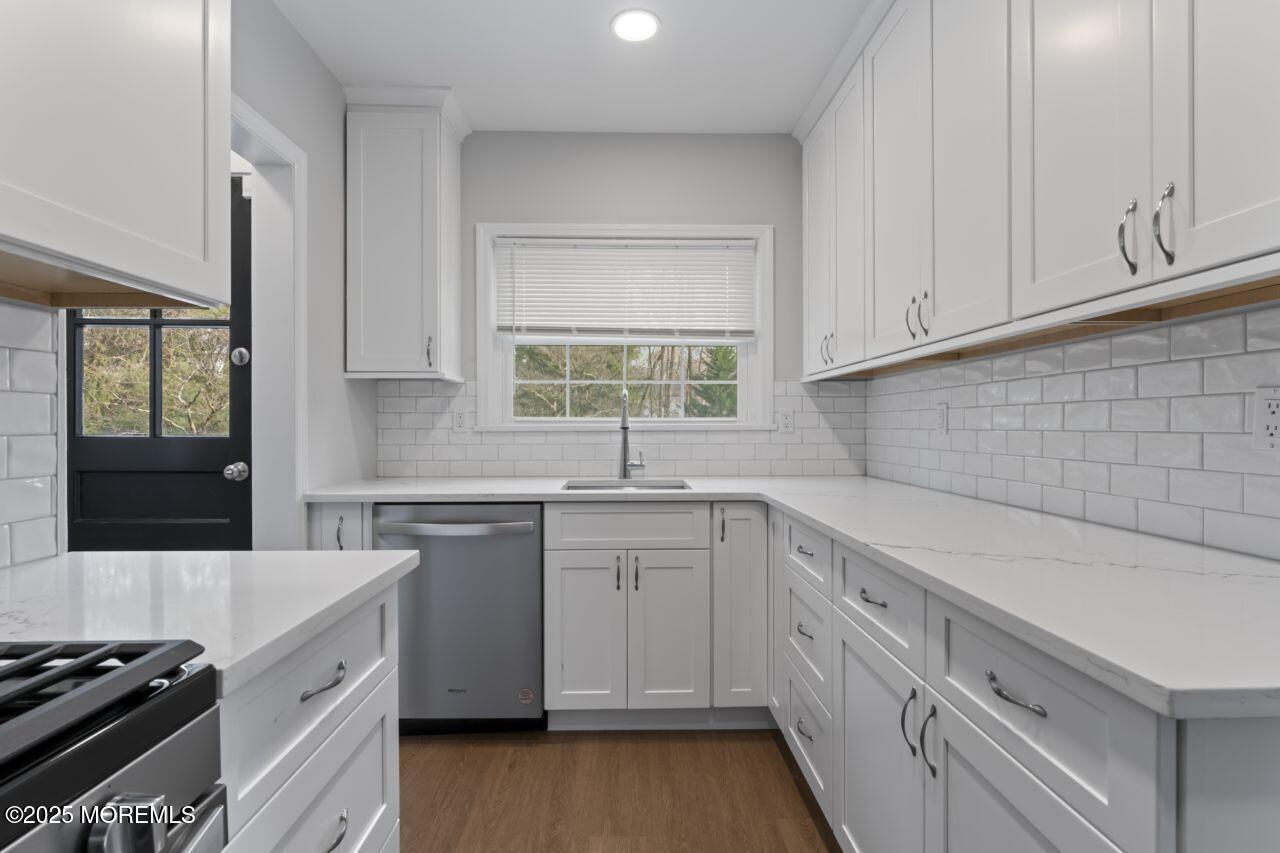 31 Phalanx Road Lincroft, NJ 07738 - Photo 8 of 28 a kitchen with a sink stove and cabinets