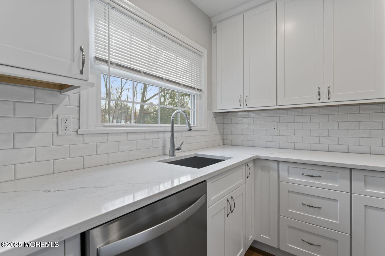31 Phalanx Road Lincroft, NJ 07738 - Photo 10 of 28 a kitchen with a sink and cabinets