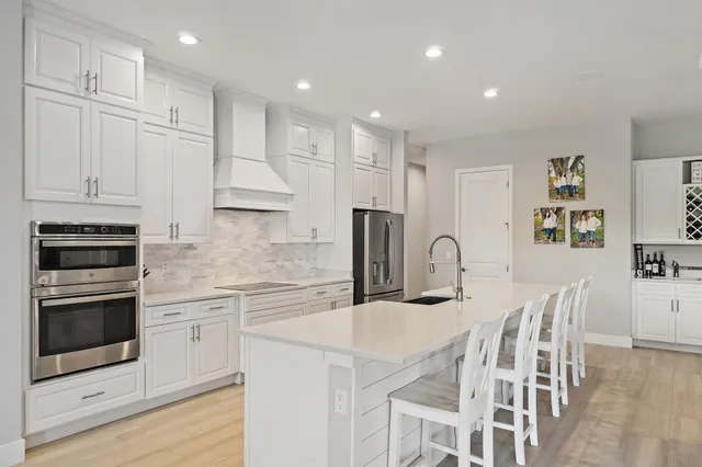 a view of a swimming pool with a table chairs and a backyard
