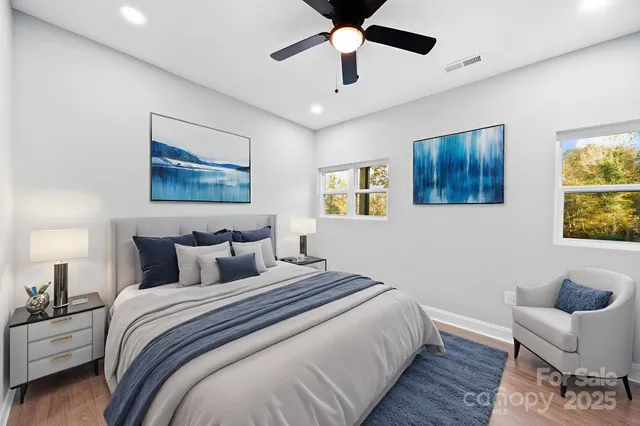 a bedroom with a large bed and a painting on the wall