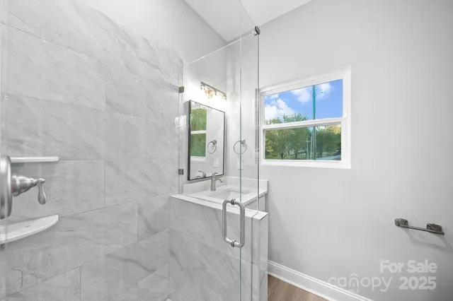 a bathroom with a window and shower