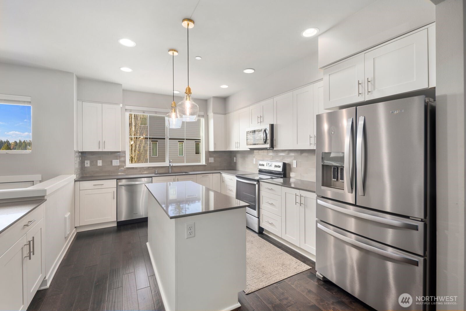 1325 Seattle Hill Road, Unit A2 Bothell, WA 98012 - Photo 6 of 34 a kitchen with white cabinets and stainless steel appliances