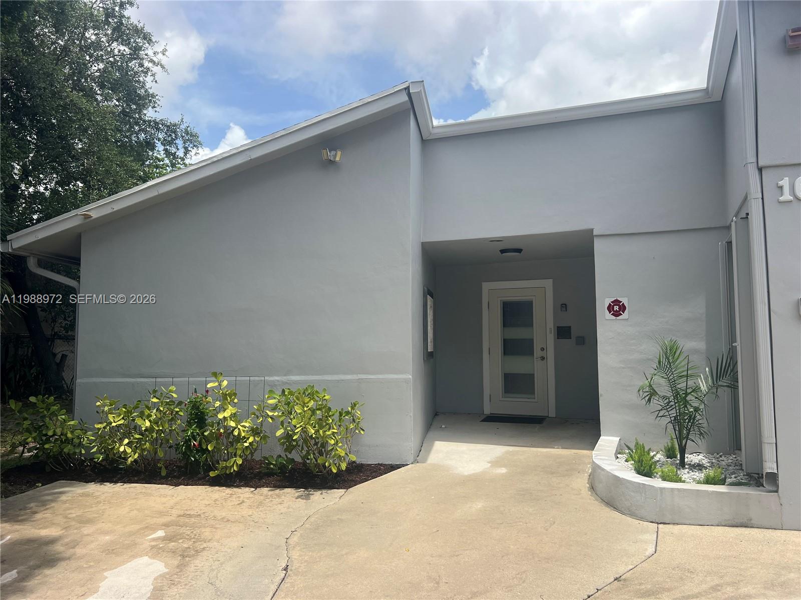 1633 Northwest 4th Street Boca Raton, FL 33486 - Photo 2 of 29 a front view of a house with a yard