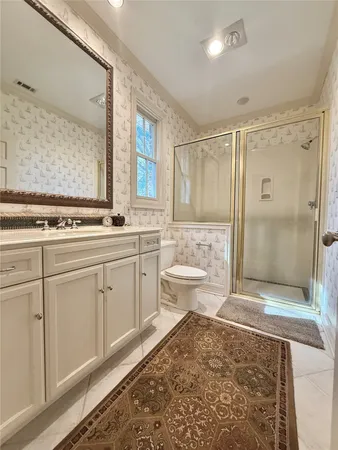 a bathroom with a sink toilet and shower