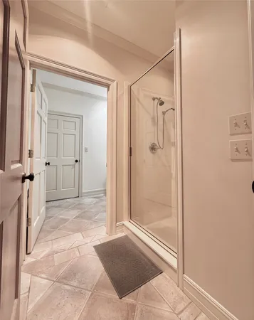 a bathroom with a shower and a glass door