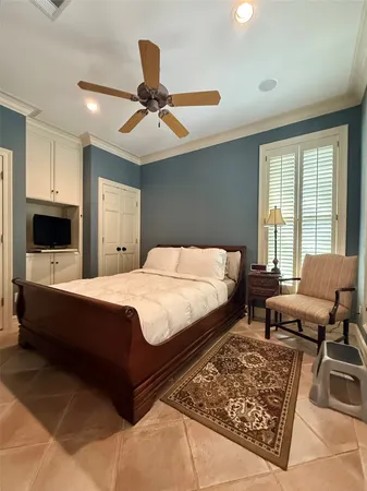 a bed room with a bed a couch and a window