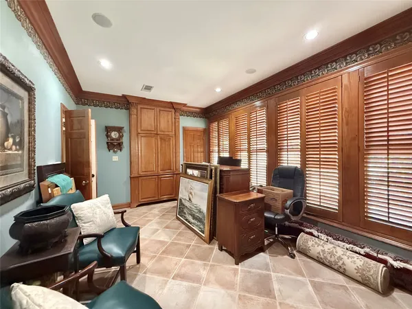 a living room with furniture and large windows