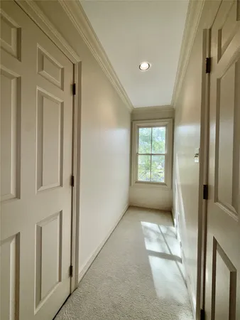 a view of hallway with windows and brick walls