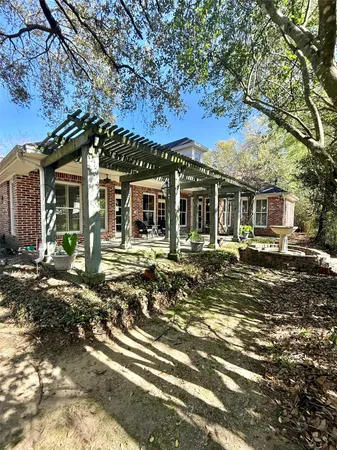 a view of a patio with table and chairs potted plants with floor to ceiling window