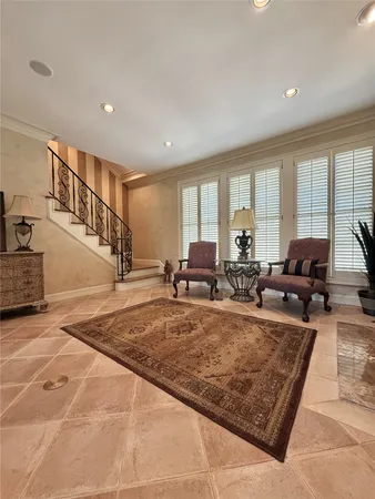 a living room with furniture hard wood floor and a large window
