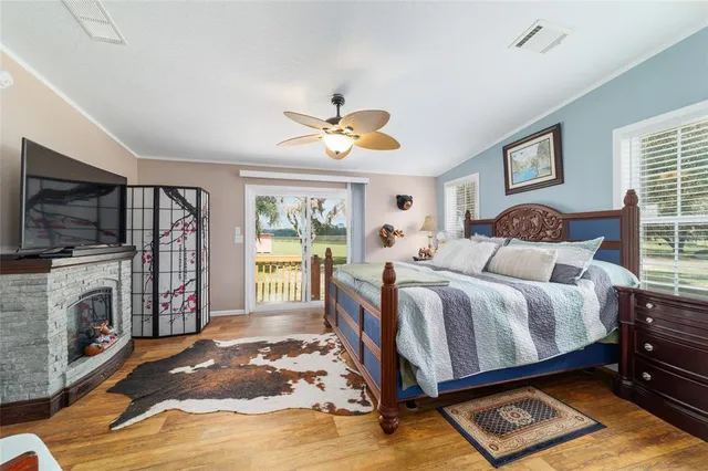 a bathroom with a glass shower door and a wooden floor