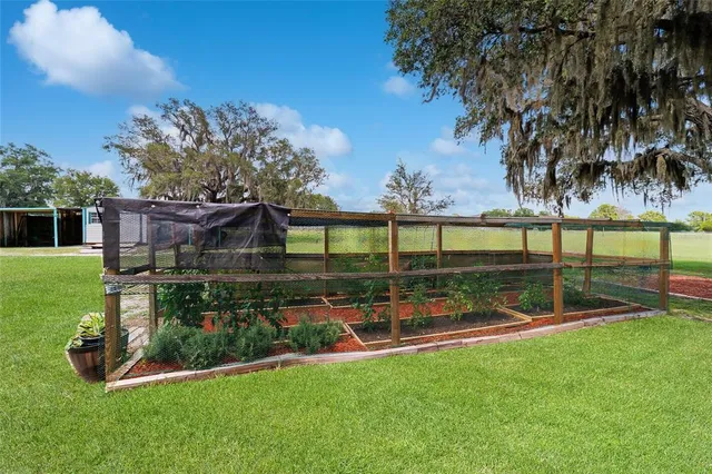 a swimming pool with outdoor seating and yard