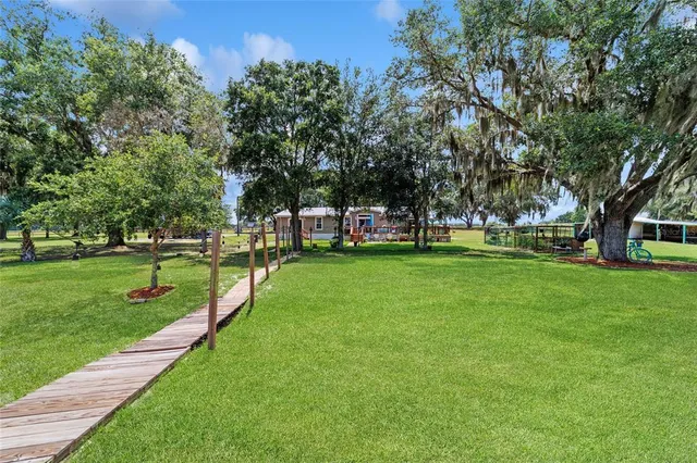 a swimming pool with outdoor seating and yard