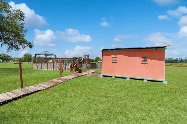 a backyard of a house with barbeque oven table and chairs