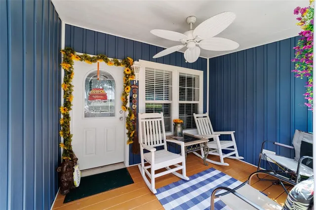 a large white kitchen with a stove a sink dishwasher and a refrigerator with wooden floor