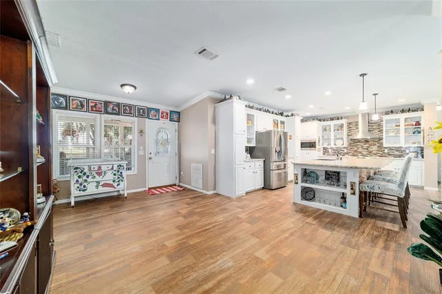 a living room with furniture wooden floor and a flat screen tv