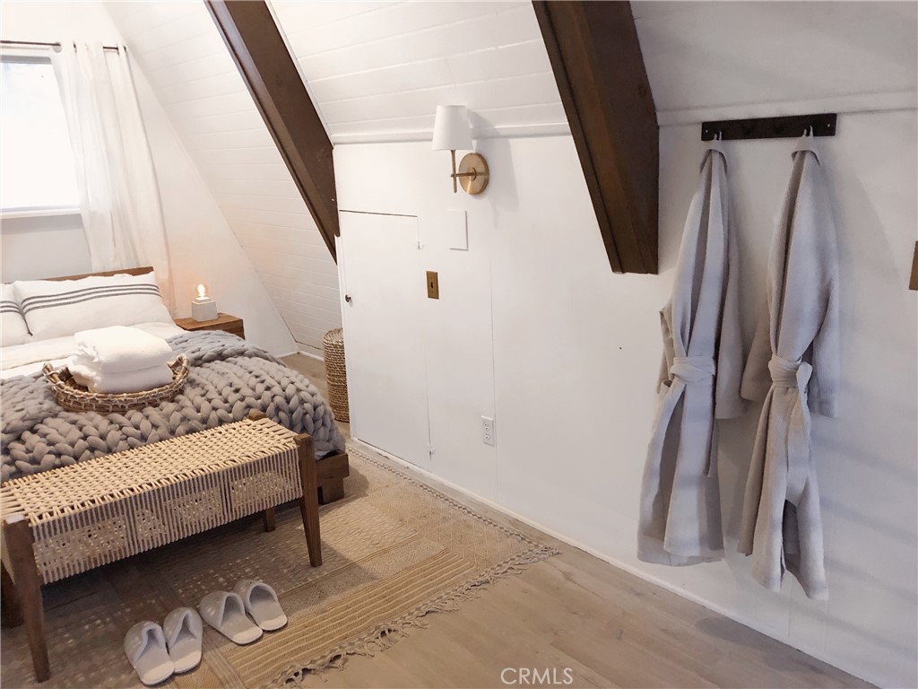 911 Kuffel Canyon Road Lake Arrowhead, CA 92385 - Photo 14 of 23 a bedroom with a bed and a window