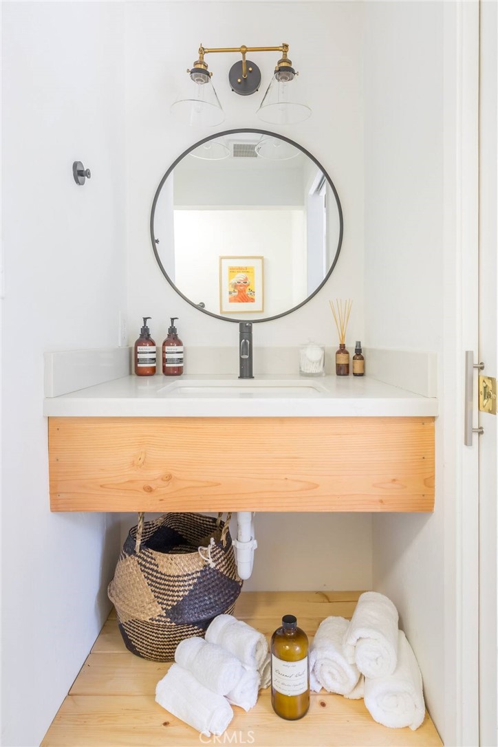 911 Kuffel Canyon Road Lake Arrowhead, CA 92385 - Photo 16 of 23 a bathroom with a sink mirror and vanity
