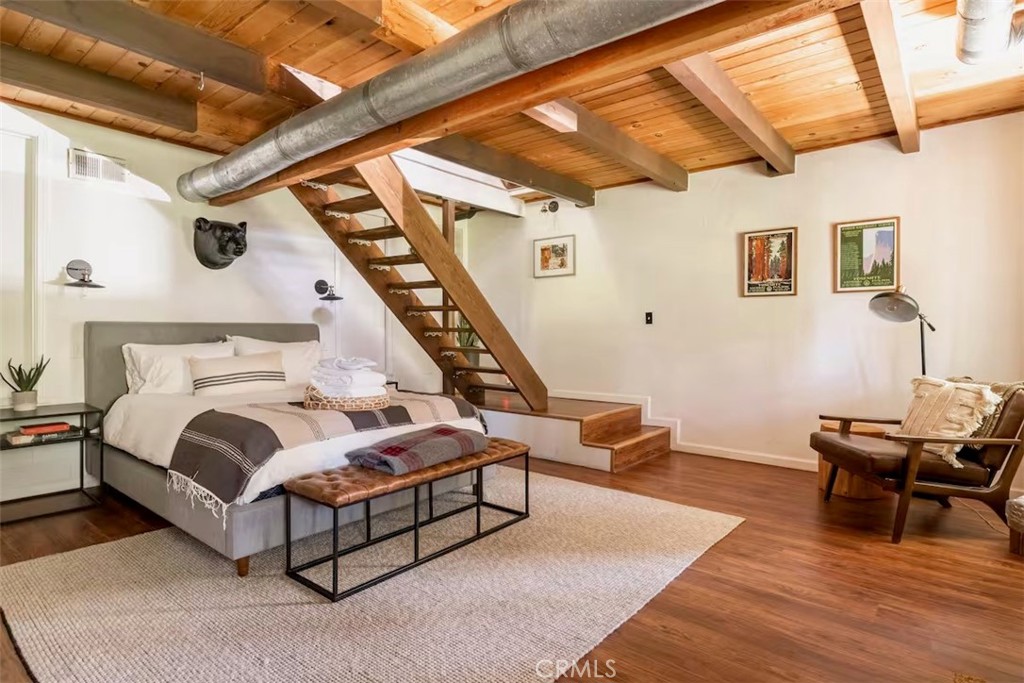 911 Kuffel Canyon Road Lake Arrowhead, CA 92385 - Photo 20 of 23 a bedroom with furniture and wooden floor