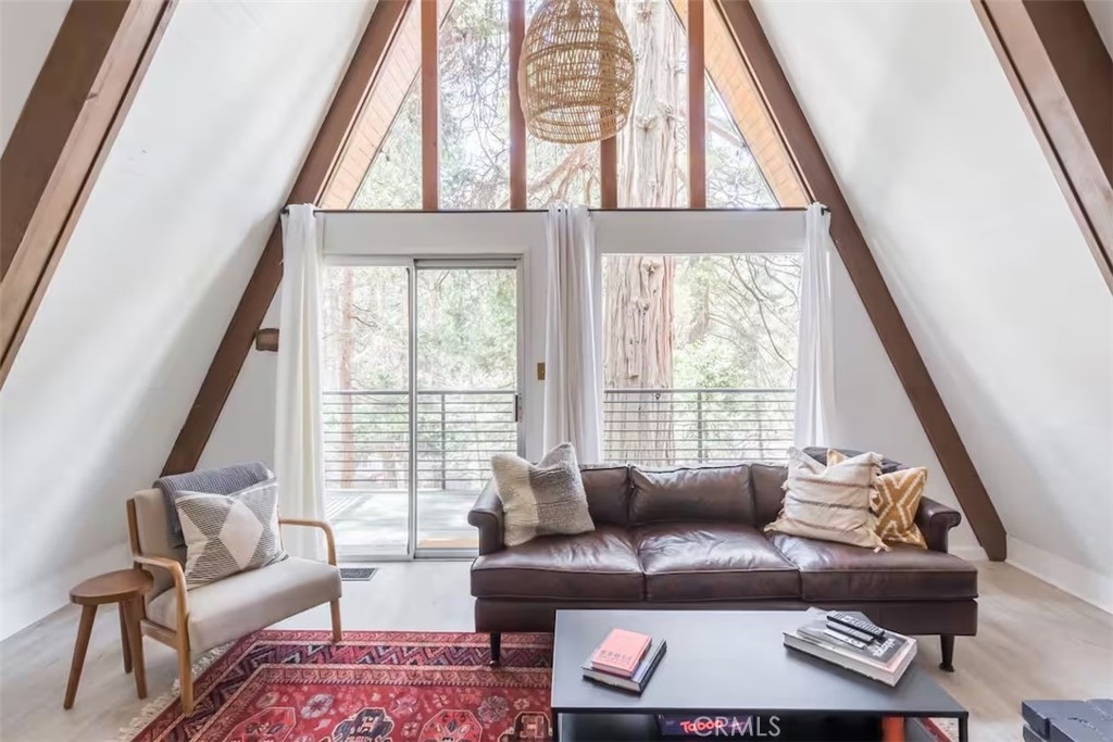 911 Kuffel Canyon Road Lake Arrowhead, CA 92385 - Photo 2 of 23 a living room with furniture and a large window
