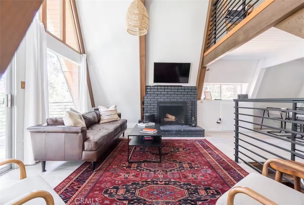 911 Kuffel Canyon Road Lake Arrowhead, CA 92385 - Photo 4 of 23 a living room with furniture or couch and a fireplace