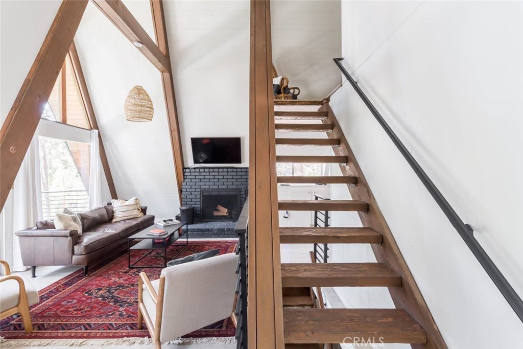 911 Kuffel Canyon Road Lake Arrowhead, CA 92385 - Photo 8 of 23 a living room with furniture and a floor to ceiling window