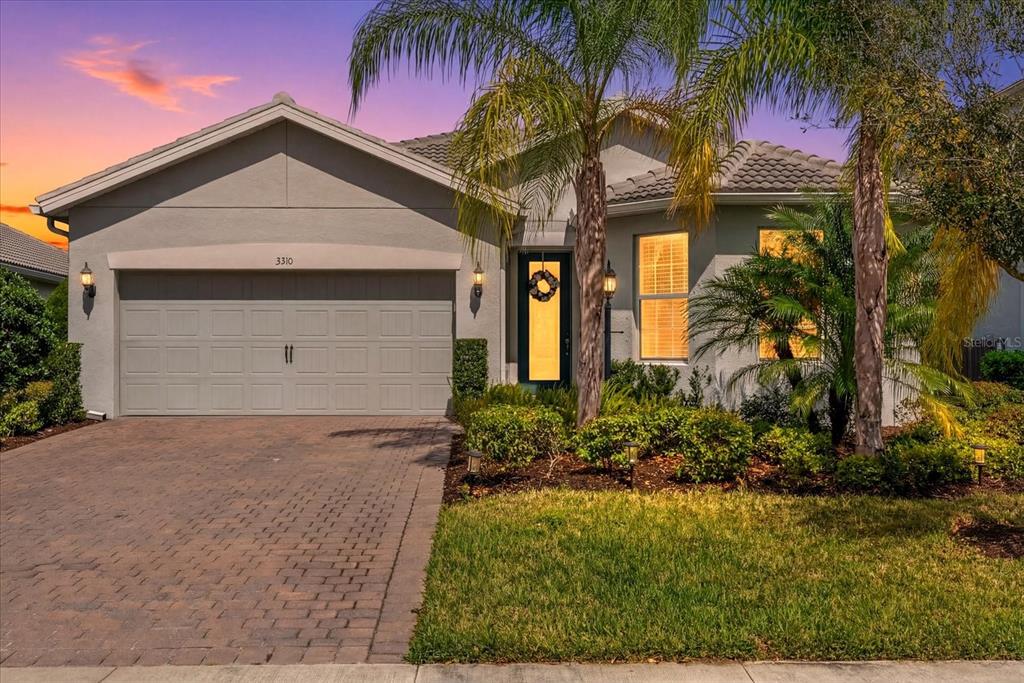 a front view of a house with a yard and garage
