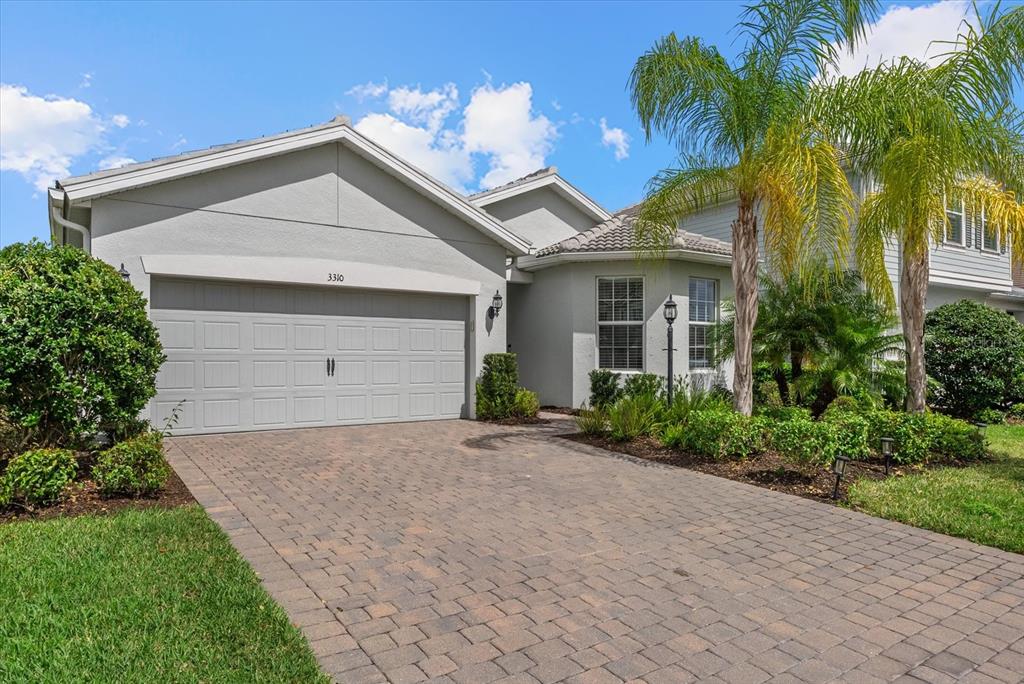 3310 Chestertown Loop Bradenton, FL 34211 - Photo 2 of 71 a view of a house with a yard and palm trees