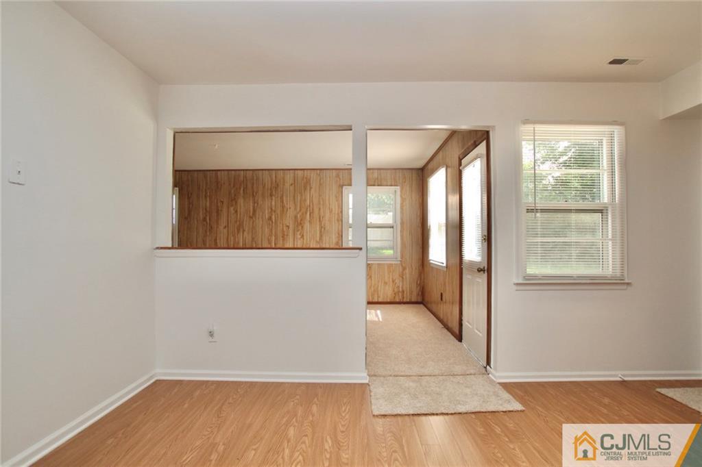 50 Roxy Avenue Edison, NJ 08820 - Photo 8 of 25 an empty room with wooden floor and windows