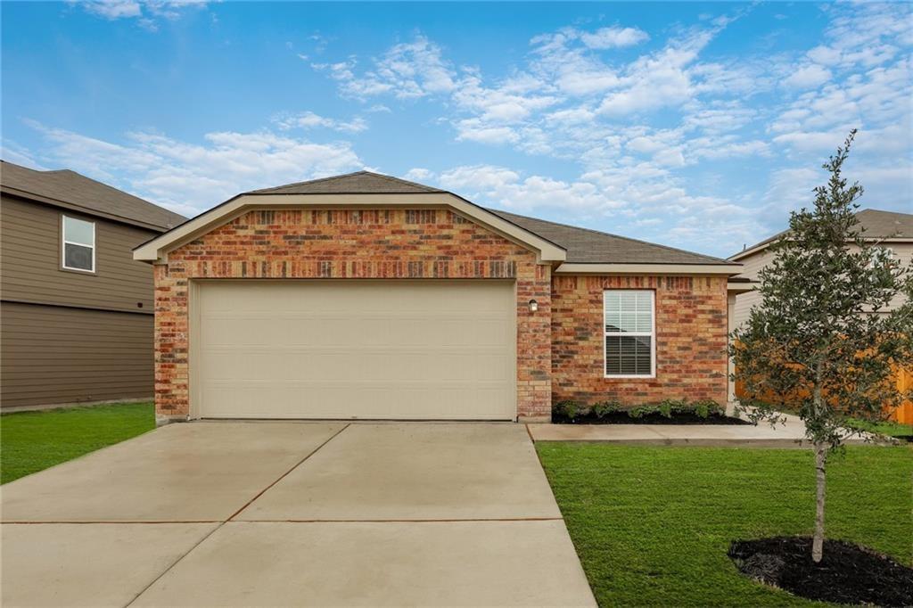 217 Sunnymeade Lane Jarrell, TX 76537 - Photo 1 of 10 A classic brick facade and a tidy lawn offer a welcoming front presentation.