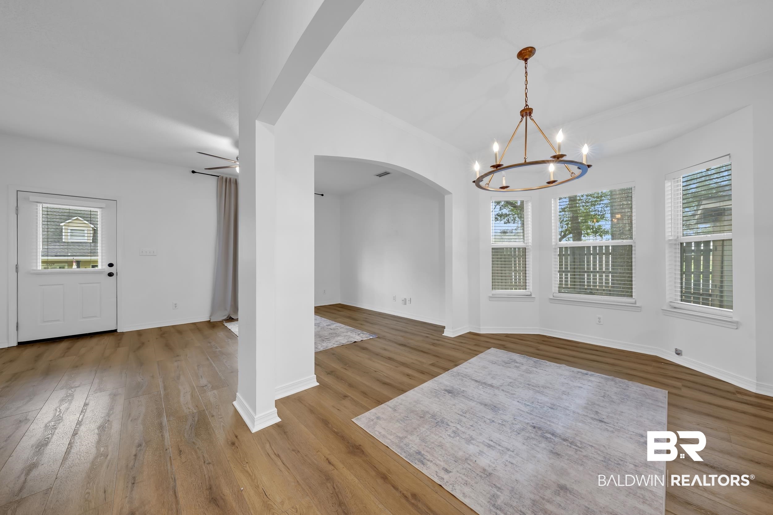 17488 Pandion Ridge, Unit A1 Fairhope, AL 36532 - Photo 6 of 18 Open-concept living space featuring wood-finish flooring throughout